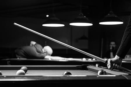 Grayscale Photo of Man Holding Cue-stick thumbnail