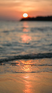 selective focus photography of body of water during golden hour thumbnail