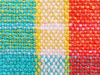 teal, yellow, white, and red knitted rug thumbnail