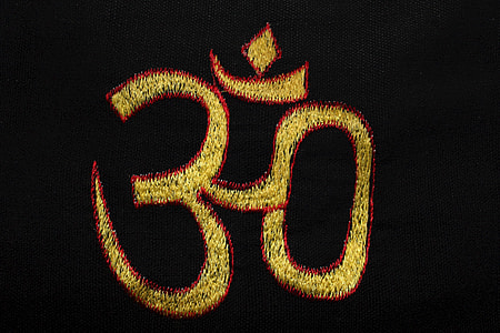 aum embroidered on black garment thumbnail