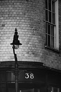 grayscale photography of light post near building thumbnail