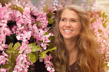 Photo of Woman Standing Beside Pink Flowers thumbnail