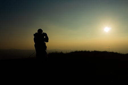 silhouette of person taking photo thumbnail