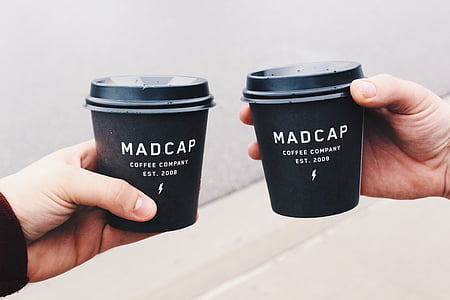 person holding coffee cup thumbnail