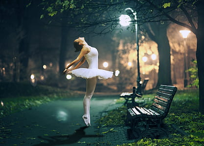ballerina posing in front of bench during nighttime thumbnail