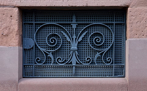 person taking photo of blue wrought iron gate thumbnail