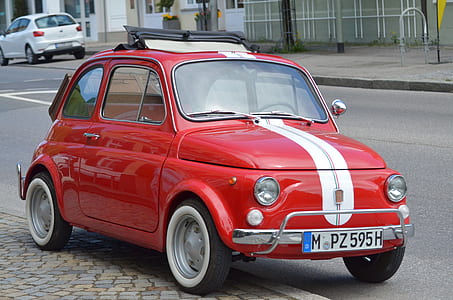classic red and white vehicle on road thumbnail