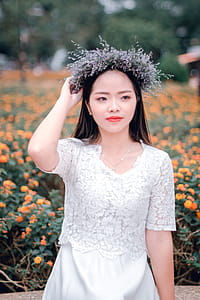 Selective Focus Photography of Woman in the Middle of Flower Field thumbnail
