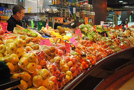 man standing behind fruits display thumbnail