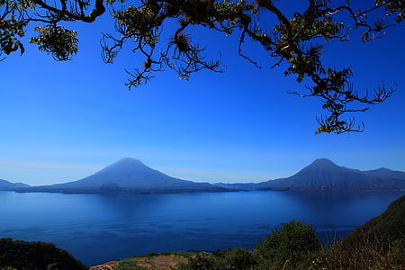 body of water in front of two mountains thumbnail