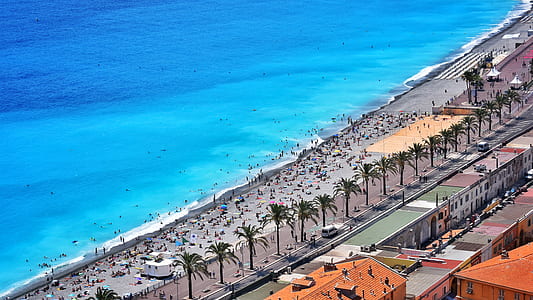 aerial photography of people on beach with blue seat at daytime thumbnail