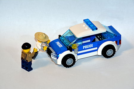 LEGO minifig near blue police toy car thumbnail
