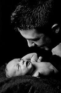 grayscale photo of man facing baby photo thumbnail