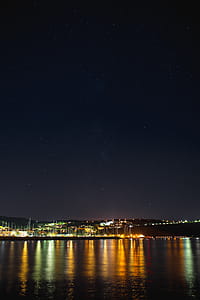 Starry sky at night over the marina, Izola, Slovenia thumbnail