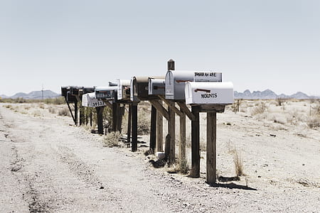 assorted-color metal mailbox lot in a desert thumbnail