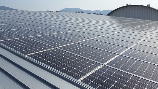 solar panels on top of gray building thumbnail