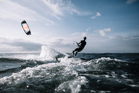 man riding on surfboard during daytime thumbnail