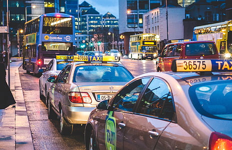 gray taxi's on road at night time thumbnail