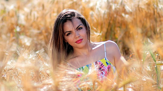 woman standing behind the grass thumbnail