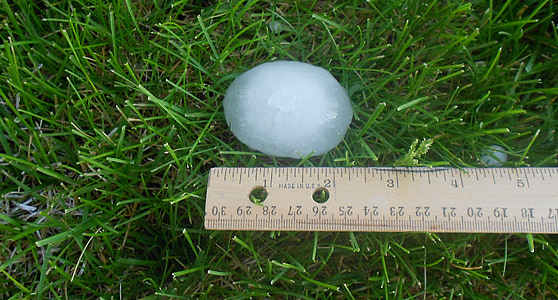 closeup photo of ice on grass beside tape measure thumbnail