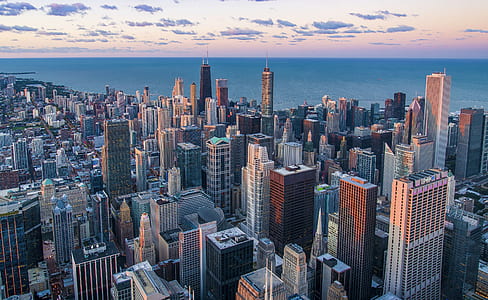 aerial view of city buildings near body of water thumbnail