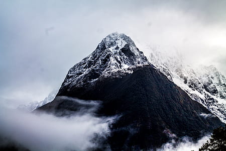 snow capped mountain under white skies thumbnail