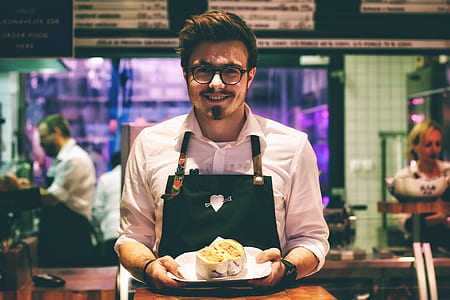 man carrying cooked food on plate thumbnail