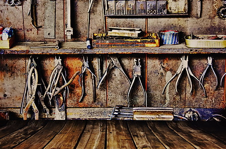 gray metal pliers hanged in wall inside room thumbnail