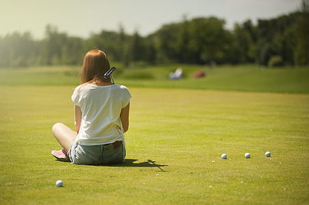 Photo of Woman Sitting on Grass Field thumbnail