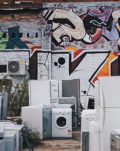 home appliance beside graffiti wall thumbnail