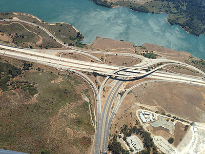 aerial photography of road near body of water during daytimer thumbnail