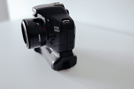 black Canon EOS 550D camera on white surface thumbnail