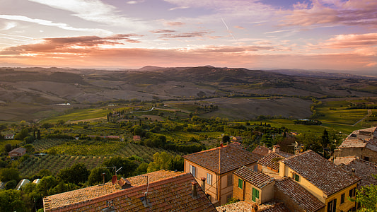 beige and brown houses on green mountain thumbnail