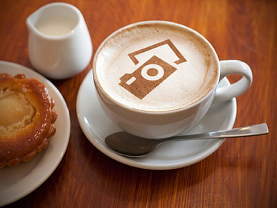 white ceramic tea cup beside spoon in saucer on wooden desk thumbnail