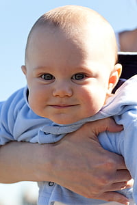person holding smiling baby thumbnail