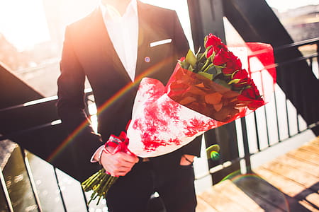 Gentleman Holding a Bouquet of Roses and Waiting for His Wife thumbnail