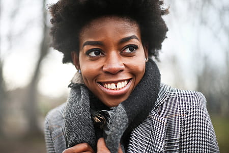 A young African woman with curly hair posing outdoors on winter day thumbnail