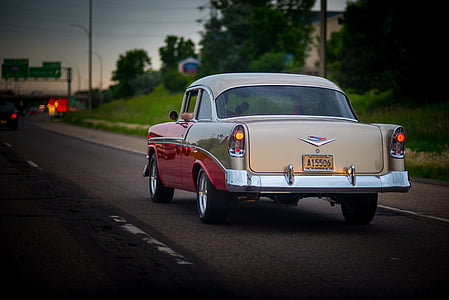 classic beige and red coupe on road thumbnail