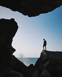 rule of thirds photography of man standing on stone formation thumbnail