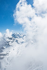 brown mountain covered by snow during daytime thumbnail