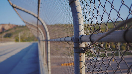 closeup photography of gray metal link fence during daytime photography thumbnail