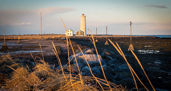 person taking photo of lighthouse thumbnail