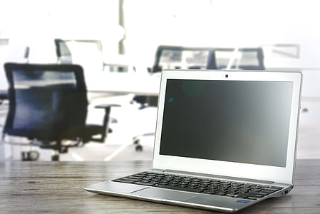 silver laptop computer on desk thumbnail