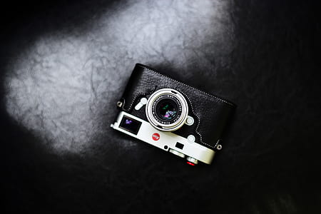 black and silver SLR camera on surface thumbnail