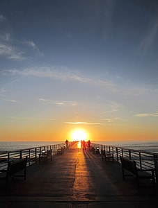 people on pier during sunrise thumbnail