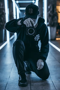 man holding camera inside room thumbnail