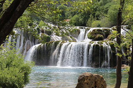 waterfalls surrounded with green trees thumbnail