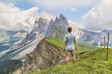 man standing near top of mountain during daytime thumbnail