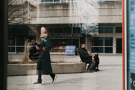 woman walking in front of building thumbnail