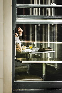 woman wearing white and black off-shoulder in-front of table inside room thumbnail